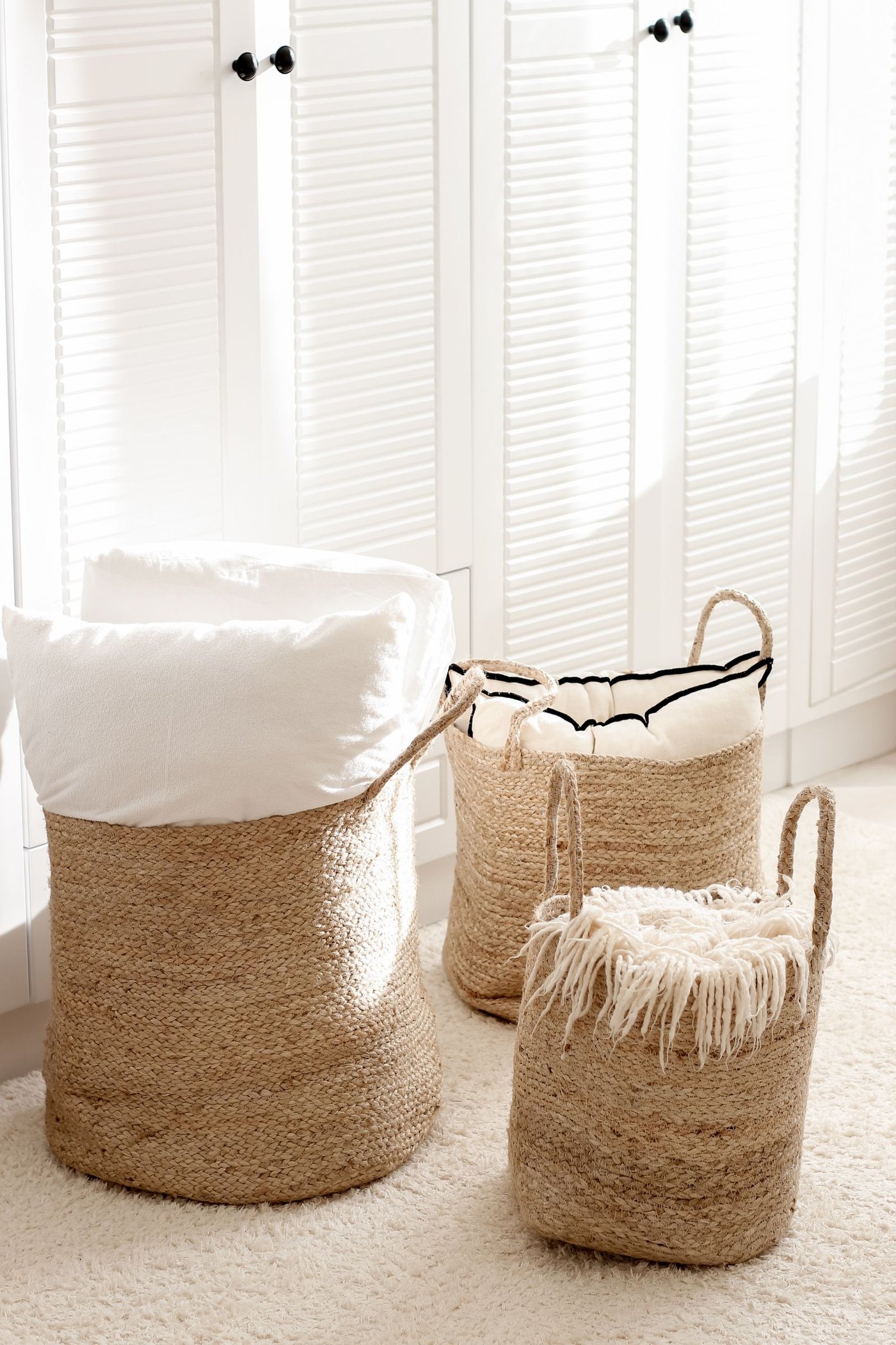 Neatly woven storage baskets on a shelf, styled for affordable fall organization.