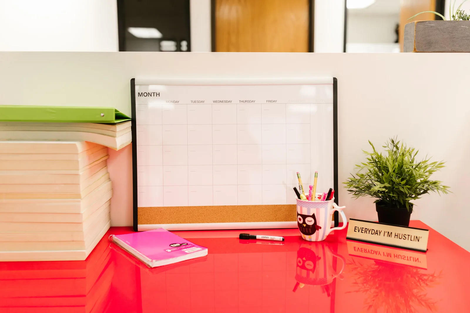 Tidy planning desk with calendar, books, and stationery organized in one place
